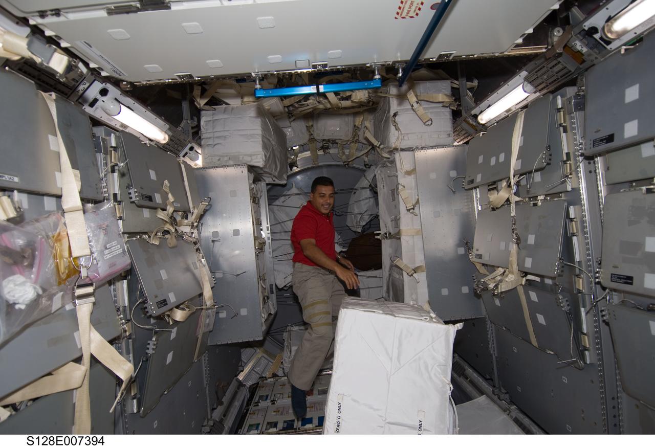S128-E-007394 (1 Sept. 2009) --- NASA astronaut Jose Hernandez, STS-128 mission specialist, works in the Leonardo Multi-Purpose Logistics Module (MPLM), temporarily attached to the International Space Station while Space Shuttle Discovery remains docked with the station.