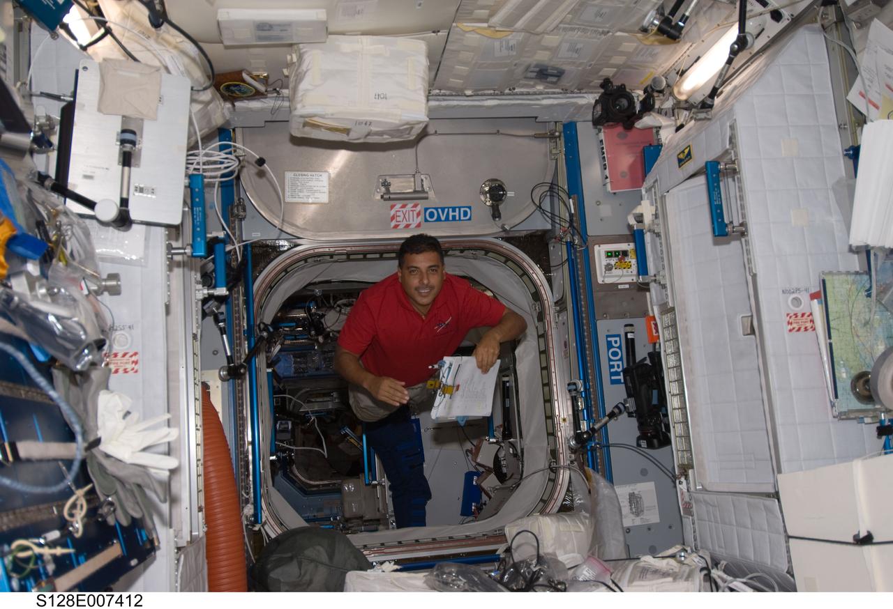 S128-E-007412 (1 Sept. 2009) --- NASA astronaut Jose Hernandez, STS-128 mission specialist, floats through a hatch into the Harmony node of the International Space Station while Space Shuttle Discovery remains docked with the station.
