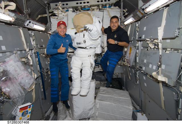 NASA image: Sturckow poses with EMU in MPLM