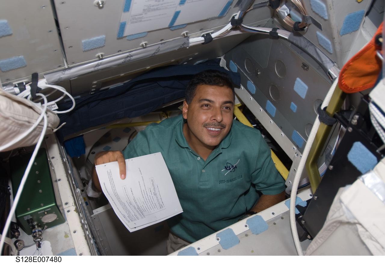 S128-E-007480 (3 Sept. 2009) --- NASA astronaut Jose Hernandez, STS-128 mission specialist, is pictured in the hatch which connects the flight deck and middeck of Space Shuttle Discovery while docked with the International Space Station.