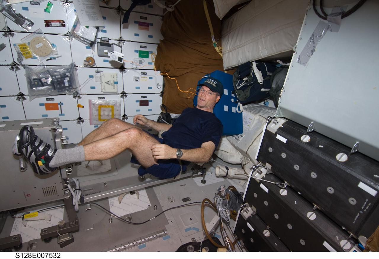 S128-E-007532 (4 Sept. 2009) ---- Astronaut Kevin Ford,  STS-128 pilot, works out on the bicycle ergometer on the middeck of the Space Shuttle Discovery.  The shuttle is currently docked with the International Space Station while the STS-128 astronauts work with the Expedition 20 crewmembers aboard the orbital outpost.