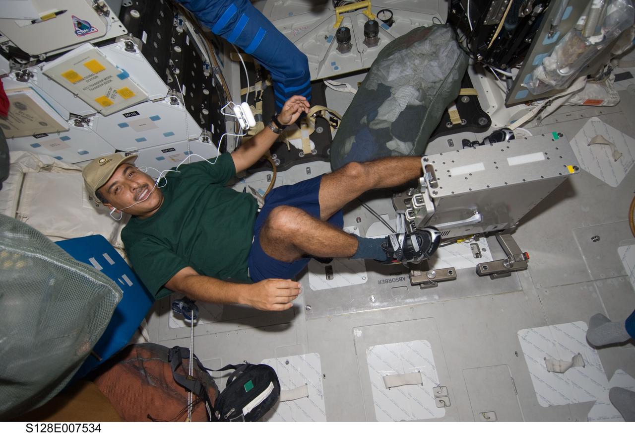 S128-E-007534 (4 Sept. 2009) ---- Astronaut Jose Hernandez, STS-128 mission specialist, works out on the bicycle ergometer on the middeck of the Space Shuttle Discovery.  The shuttle is currently docked with the International Space Station while the STS-128 astronauts work with the Expedition 20 crewmembers aboard the orbital outpost.