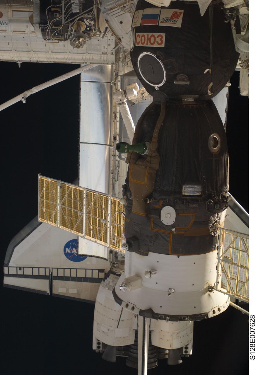 S128-E-007628 (5 Sept. 2009) --- This scene, photographed from the International Space Station while docked with Space Shuttle Discovery (STS-128), shows the orbiter and a Soyuz vehicle docked with the orbital outpost.