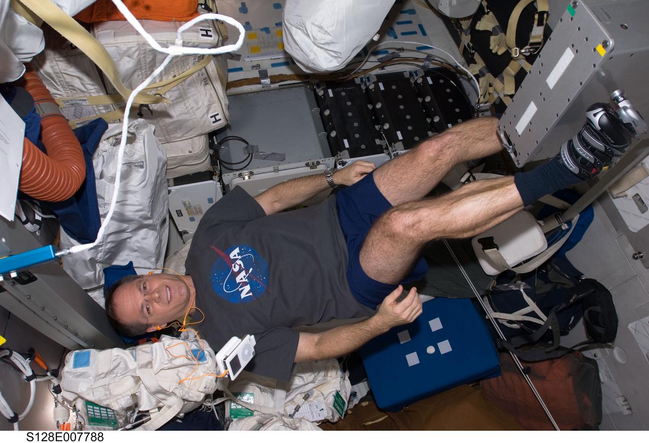 S128-E-007788 (6 Sept. 2009) --- NASA astronaut Kevin Ford, STS-128 pilot, exercises on a bicycle ergometer on the middeck of Space Shuttle Discovery while docked with the International Space Station.
