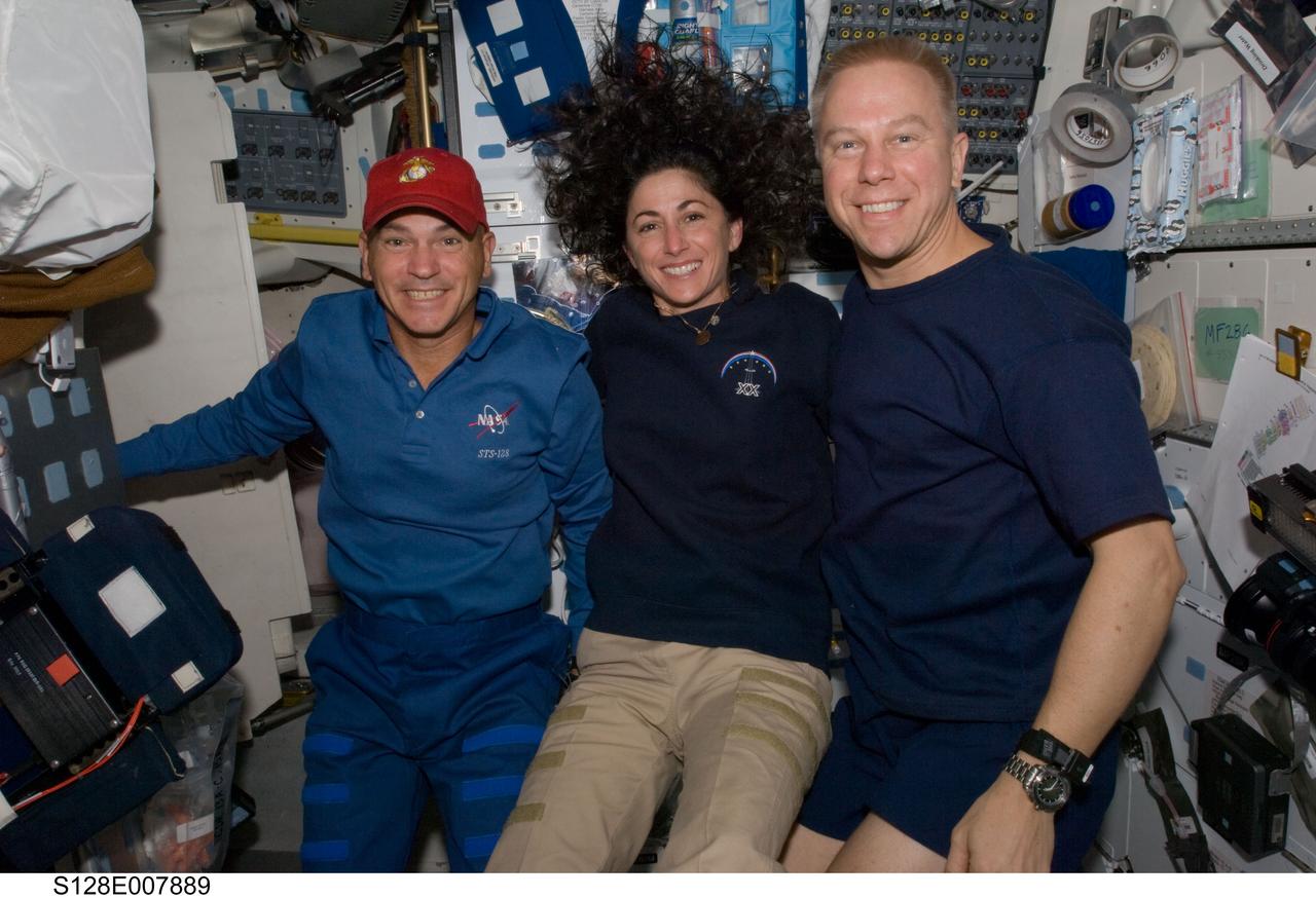 S128-E-007889 (6 Sept. 2009) --- NASA astronauts Rick Sturckow (left), STS-128 commander; Nicole Stott, Expedition 20 flight engineer; and Tim Kopra, STS-128 mission specialist, pose for a photo on the middeck of Space Shuttle Discovery while docked with the International Space Station.