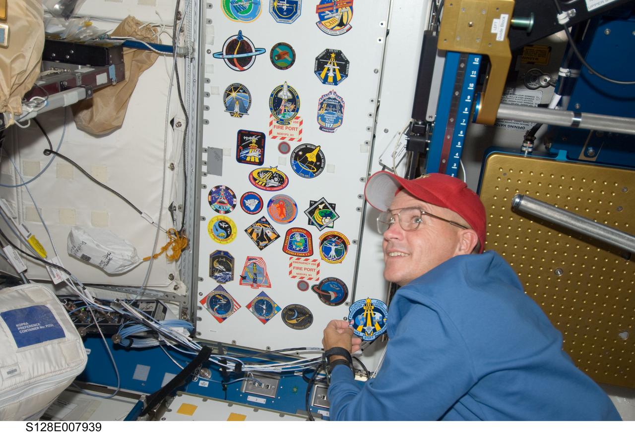 S128-E-007939 (7 Sept. 2009) --- NASA astronaut Rick Sturckow, STS-128 commander, adds his crew’s patch to the growing collection, in the Unity node, of insignias representing crews who have worked on the International Space Station.