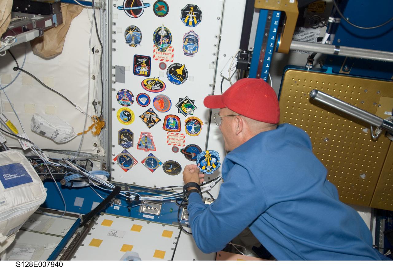 S128-E-007940 (7 Sept. 2009) --- NASA astronaut Rick Sturckow, STS-128 commander, adds his crew’s patch to the growing collection, in the Unity node, of insignias representing crews who have worked on the International Space Station.