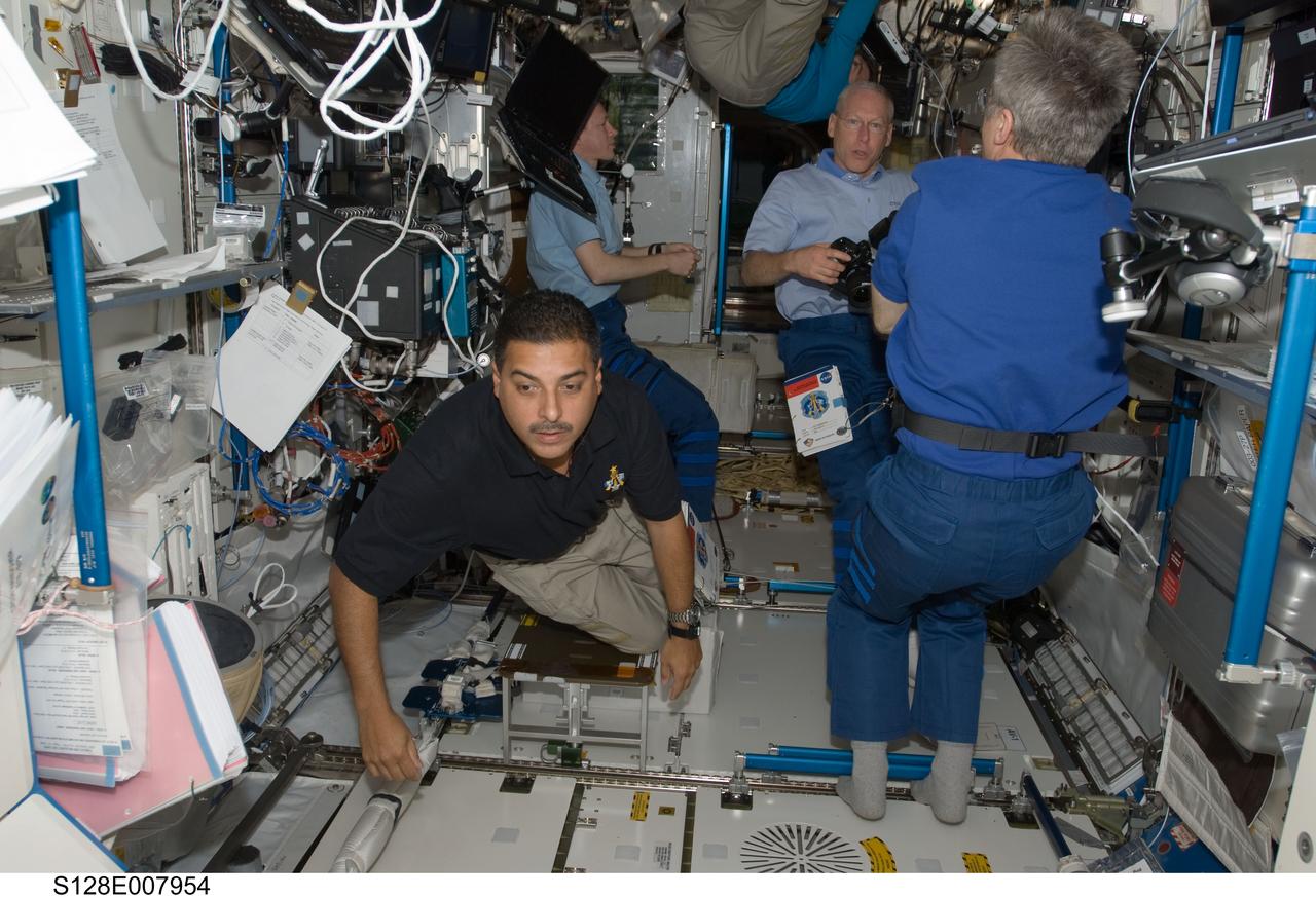 S128-E-007954 (7 Sept. 2009) --- NASA astronauts Jose Hernandez (left foreground) and Patrick Forrester (right background), both STS-128 mission specialists; and Michael Barratt (top center), Expedition 20 flight engineer; along with European Space Agency astronaut Frank De Winne (left background) and Canadian Space Agency astronaut Robert Thirsk, both Expedition 20 flight engineers, are busy with various tasks in the Destiny laboratory of the International Space Station.