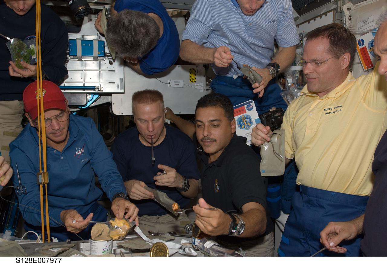 S128-E-007977 (7 Sept. 2009) --- Crew members onboard the International Space Station share a meal in the Unity node while Space Shuttle Discovery remains docked with the station. Pictured from the left (bottom) are NASA astronauts Rick Sturckow, STS-128 commander; Tim Kopra and Jose Hernandez, both STS-128 mission specialists; along with Kevin Ford, STS-128 pilot; and John “Danny” Olivas (mostly out of frame at right), STS-128 mission specialist. Pictured from the left (top, partially out of frame) are NASA astronaut Nicole Stott and Canadian Space Agency astronaut Robert Thirsk, both Expedition 20 flight engineers; along with NASA astronaut Patrick Forrester, STS-128 mission specialist.