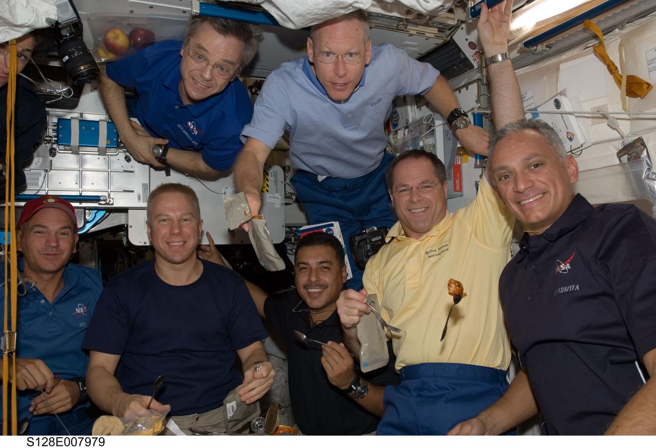 S128-E-007979 (7 Sept. 2009) --- Crew members onboard the International Space Station share a meal in the Unity node while Space Shuttle Discovery remains docked with the station. Pictured from the left (bottom) are NASA astronauts Rick Sturckow, STS-128 commander; Tim Kopra and Jose Hernandez, both STS-128 mission specialists; along with Kevin Ford, STS-128 pilot; and John “Danny” Olivas, STS-128 mission specialist. Pictured from the left (top) are NASA astronaut Nicole Stott (mostly out of frame) and Canadian Space Agency astronaut Robert Thirsk, both Expedition 20 flight engineers; along with NASA astronaut Patrick Forrester, STS-128 mission specialist.