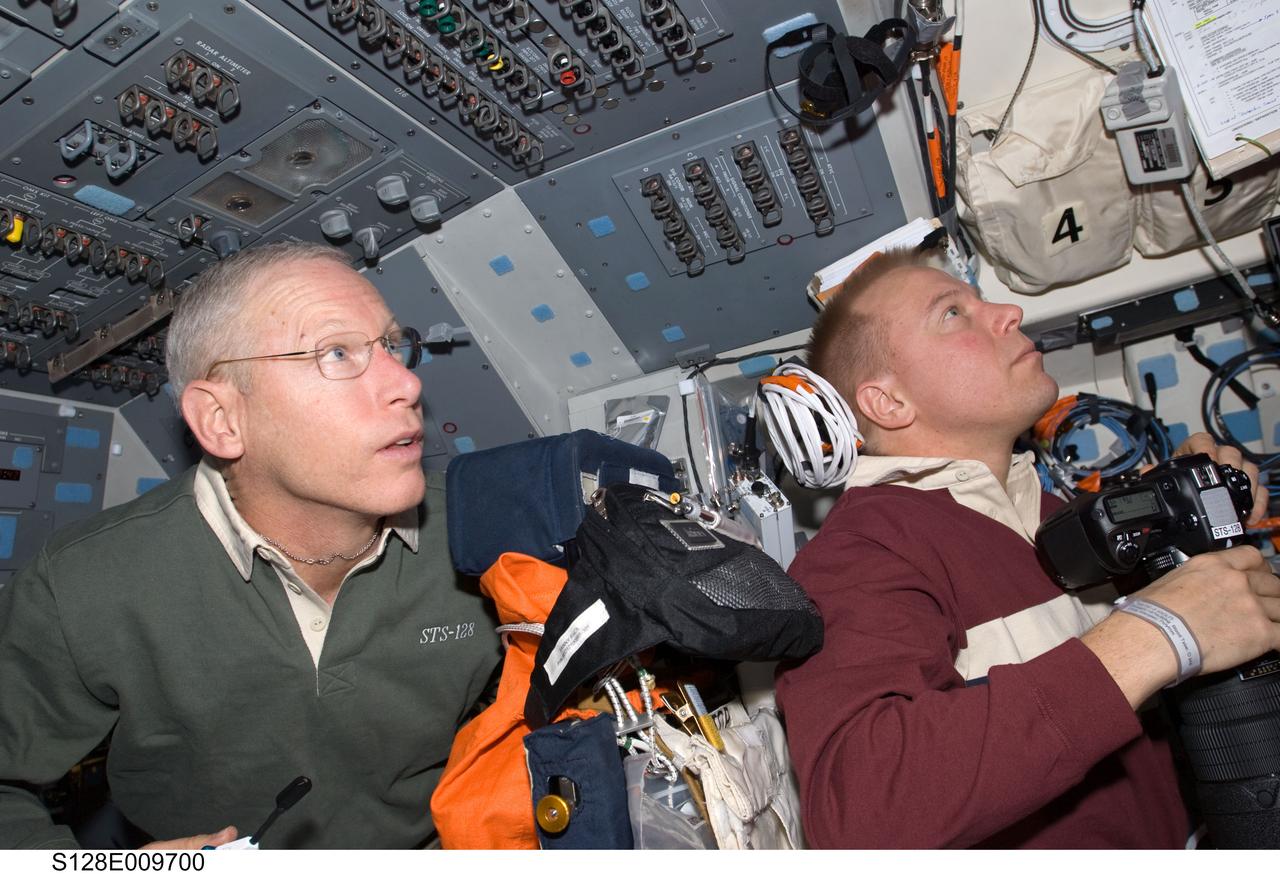S128-E-009700 (8 Sept. 2009) --- NASA astronauts Patrick Forrester (left) and Tim Kopra, both STS-128 mission specialists, are pictured on the flight deck of Space Shuttle Discovery during flight day 12 activities.