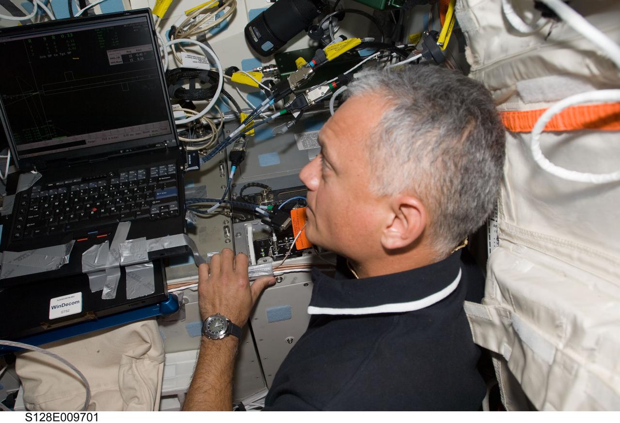 S128-E-009701 (8 Sept. 2009) --- NASA astronaut John “Danny” Olivas, STS-128 mission specialist, is pictured on the aft flight deck of Space Shuttle Discovery during flight day 12 activities.