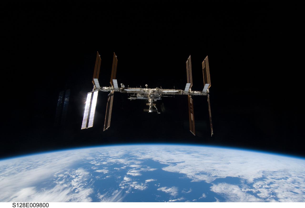 S128-E-009800 (8 Sept. 2009) --- Backdropped by Earth’s horizon and the blackness of space, the International Space Station is seen from Space Shuttle Discovery as the two spacecraft begin their relative separation. Earlier the STS-128 and Expedition 20 crew concluded nine days of cooperative work onboard the shuttle and station. Undocking of the two spacecraft occurred at 2:26 p.m. (CDT) on Sept. 8, 2009.