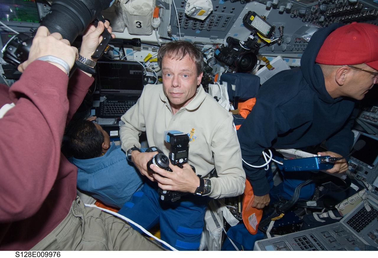 S128-E-009976 (8 Sept. 2009) --- European Space Agency astronaut Christer Fuglesang (center), NASA astronauts Jose Hernandez (left background), Tim Kopra (left mostly out of frame), all STS-128 mission specialists; along with Rick Sturckow, commander, are pictured on the flight deck of Space Shuttle Discovery during flight day 12 activities.