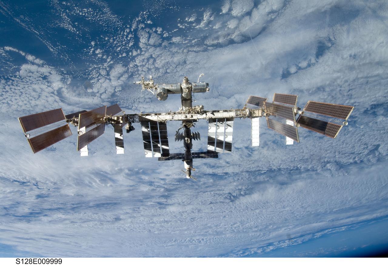 S128-E-009999 (8 Sept. 2009) --- Backdropped by a blue and white part of Earth, the International Space Station is seen from Space Shuttle Discovery as the two spacecraft begin their relative separation. Earlier the STS-128 and Expedition 20 crew concluded nine days of cooperative work onboard the shuttle and station. Undocking of the two spacecraft occurred at 2:26 p.m. (CDT) on Sept. 8, 2009.