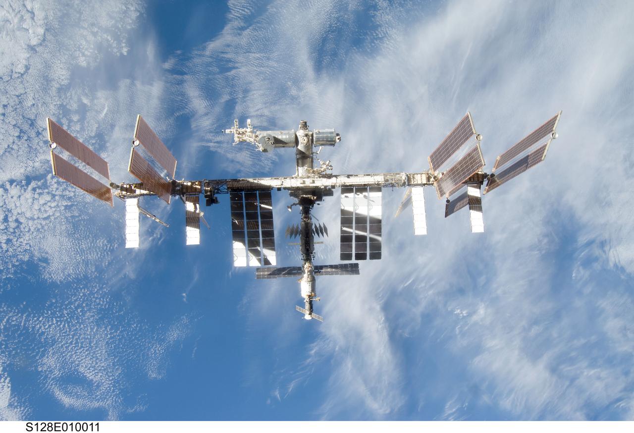 S128-E-010011 (8 Sept. 2009) --- Backdropped by a blue and white part of Earth, the International Space Station is seen from Space Shuttle Discovery as the two spacecraft begin their relative separation. Earlier the STS-128 and Expedition 20 crew concluded nine days of cooperative work onboard the shuttle and station. Undocking of the two spacecraft occurred at 2:26 p.m. (CDT) on Sept. 8, 2009.