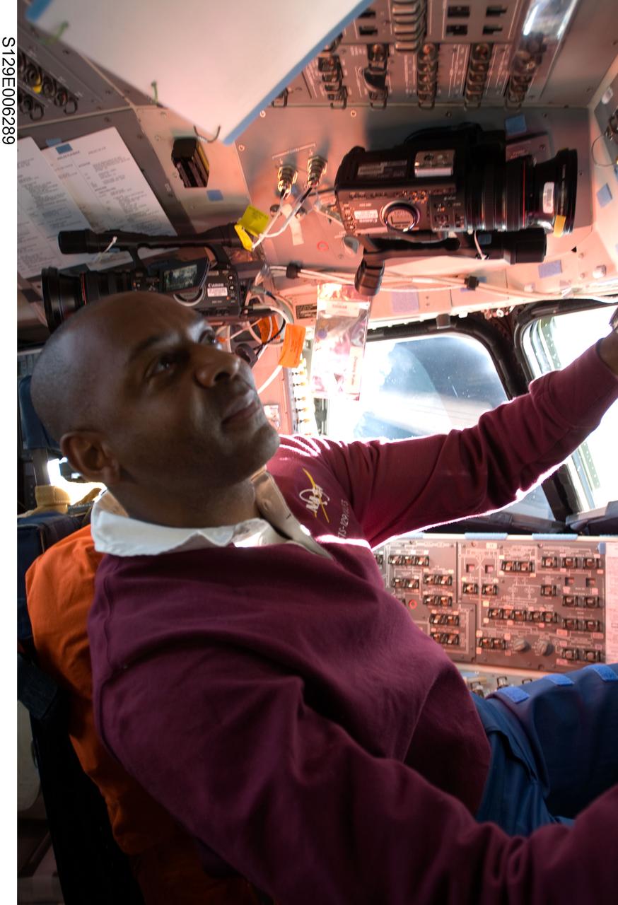 S129-E-006289 (17 Nov. 2009) --- Astronaut Robert L. Satcher Jr., STS-129 mission specialist, occupies the commander?s station on the flight deck of Space Shuttle Atlantis during flight day two activities.