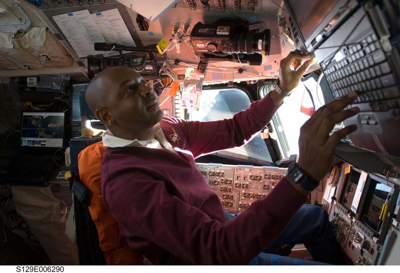 S129-E-006290 (17 Nov. 2009) --- Astronaut Robert L. Satcher Jr., STS-129 mission specialist, occupies the commander?s station on the flight deck of Space Shuttle Atlantis during flight day two activities.