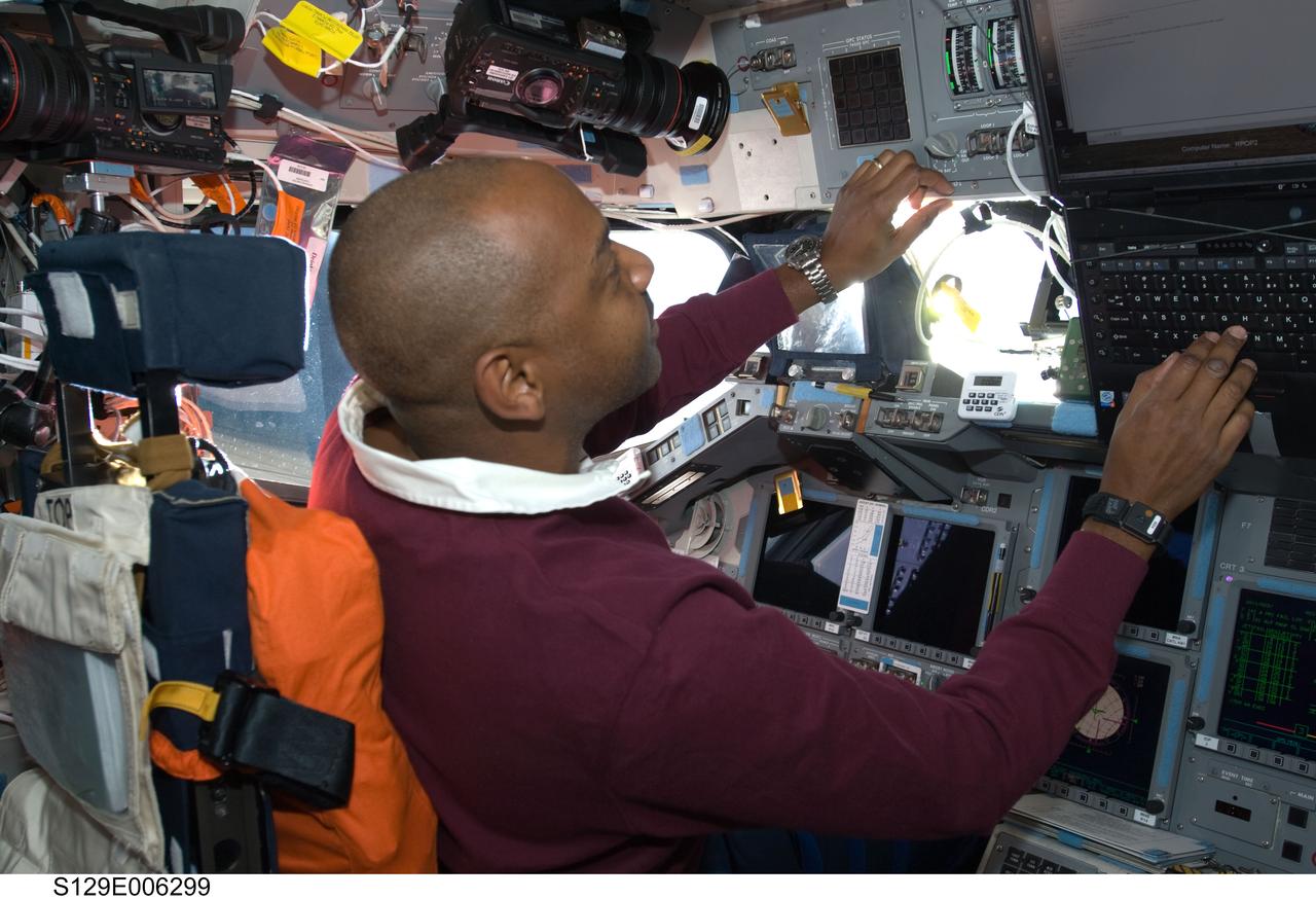 S129-E-006299 (17 Nov. 2009) --- Astronaut Robert L. Satcher Jr., STS-129 mission specialist, occupies the commander?s station on the flight deck of Space Shuttle Atlantis during flight day two activities.