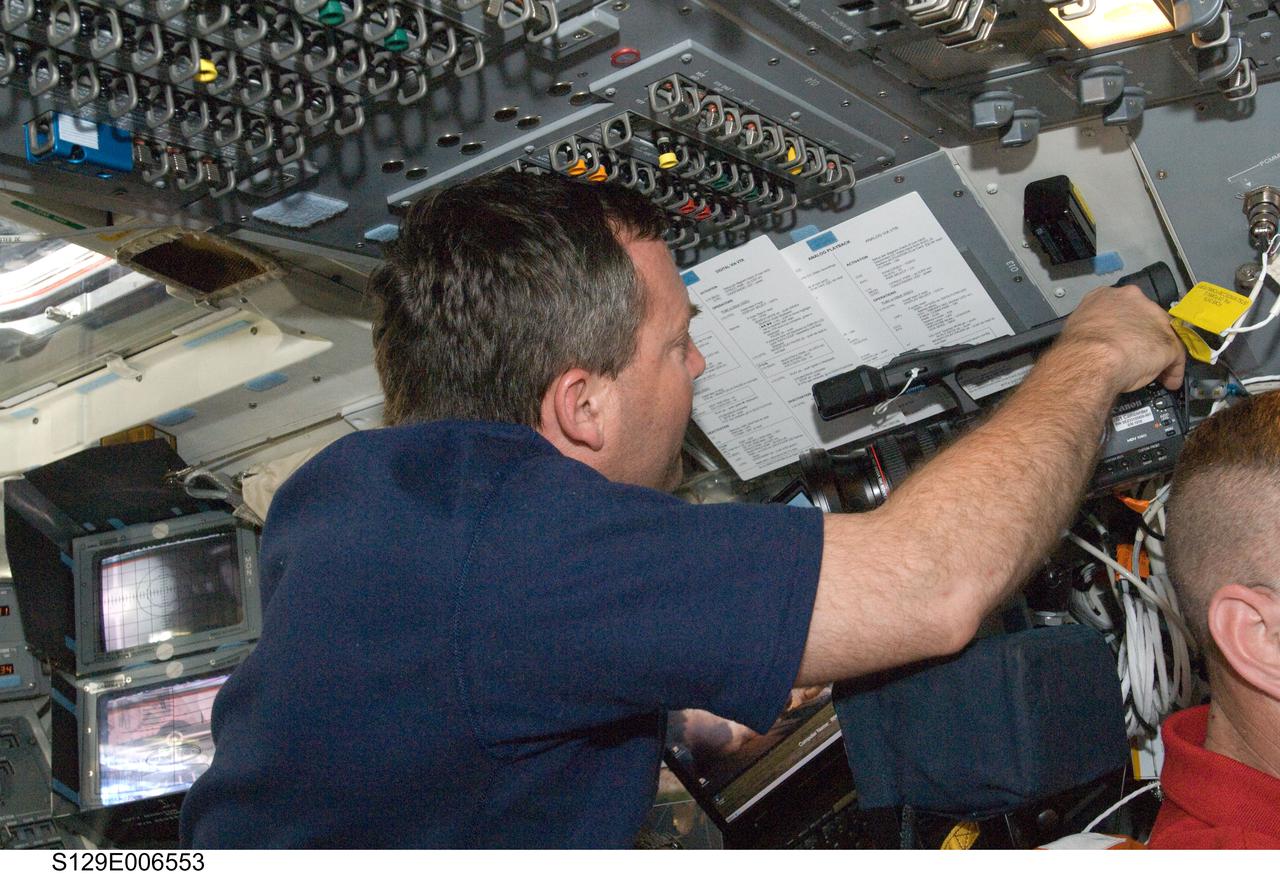 S129-E-006553 (18 Nov. 2009) --- Astronaut Mike Foreman, STS-129 mission specialist, works on the flight deck of Space Shuttle Atlantis during flight day three activities.