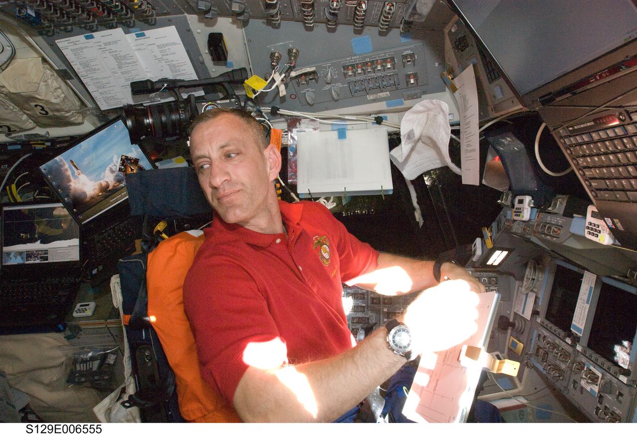 S129-E-006555 (18 Nov. 2009) --- Astronaut Charles O. Hobaugh, STS-129 commander, occupies the commander?s station on the flight deck of Space Shuttle Atlantis during flight day three activities.