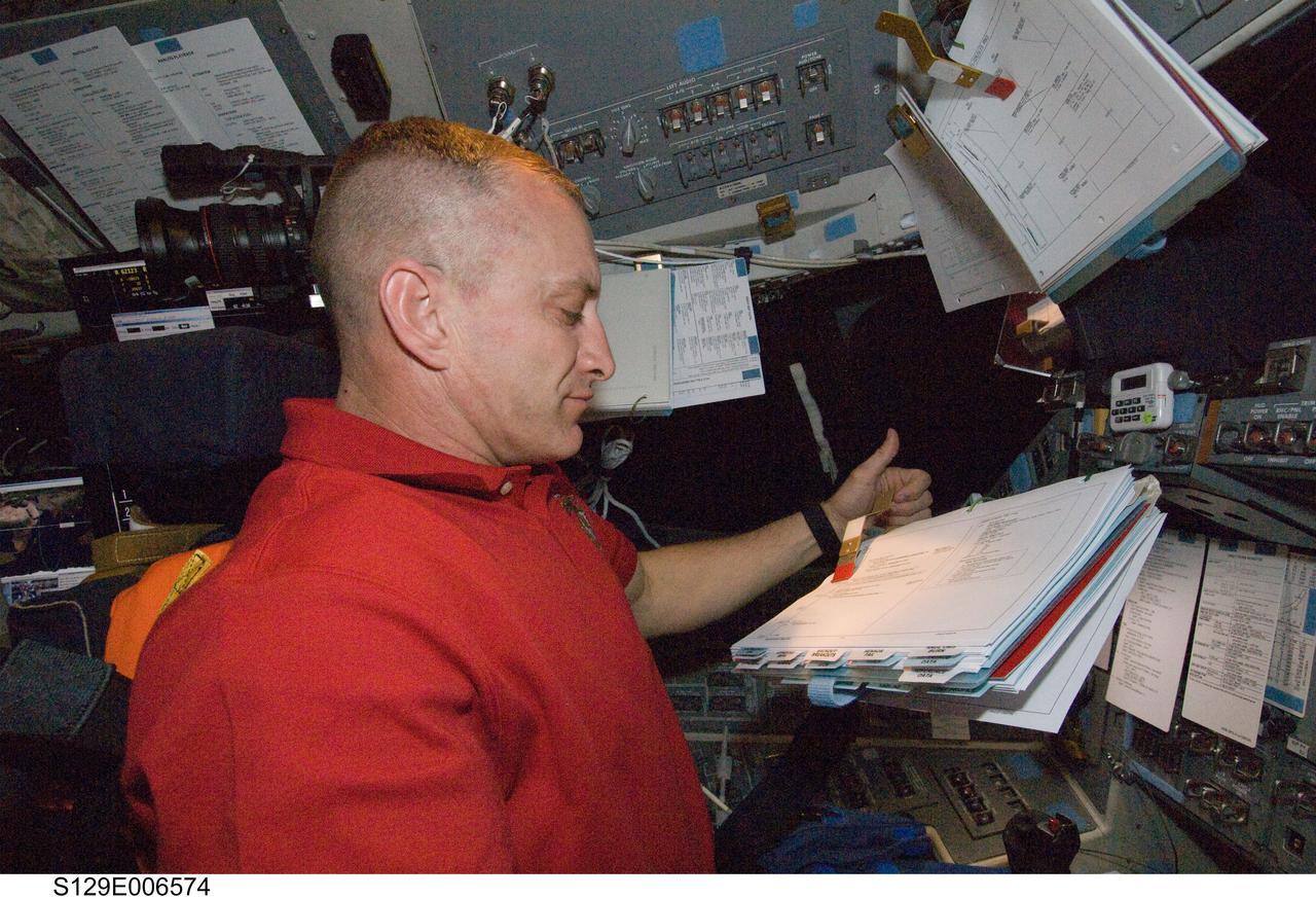 S129-E-006574 (18 Nov. 2009) --- Astronaut Charles O. Hobaugh, STS-129 commander, occupies the commander?s station on the flight deck of Space Shuttle Atlantis during flight day three activities.