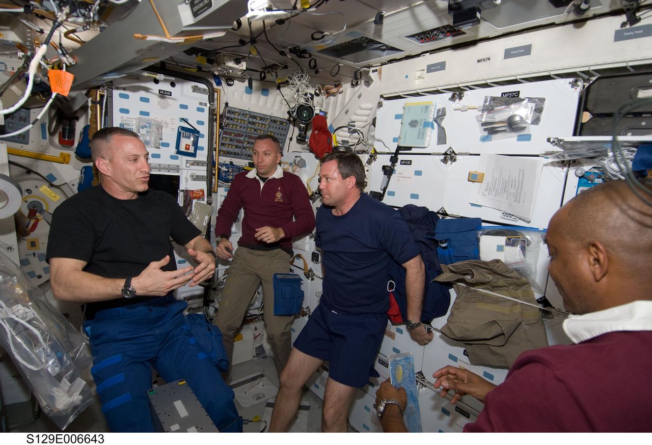 S129-E-006643 (17 Nov. 2009) --- Astronaut Charles O. Hobaugh (left), STS-129 commander, briefs his crew on the middeck of Space Shuttle Atlantis during flight day two activities. Pictured from the right are astronauts Robert L. Satcher Jr., Mike Foreman and Randy Bresnik, all mission specialists. Not pictured are astronauts Barry E. Wilmore, pilot; and Leland Melvin, mission specialist.