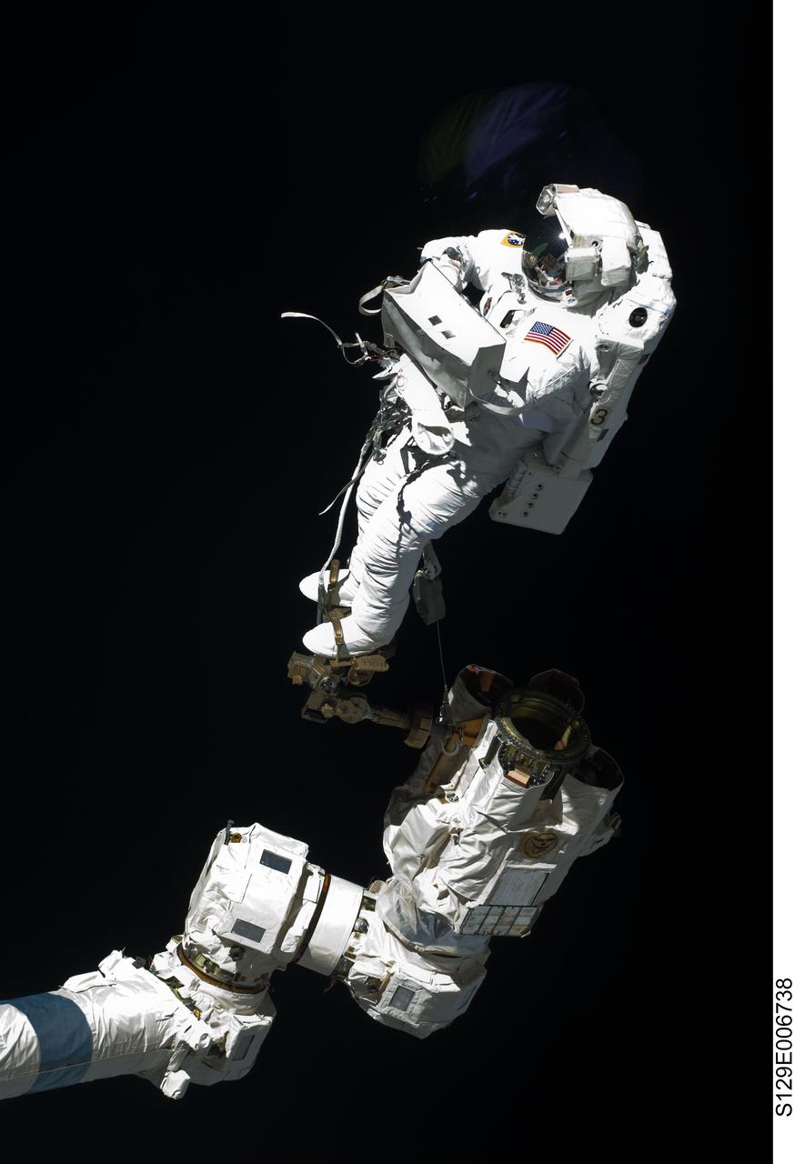 S129-E-006738 (19 Nov. 2009) --- Anchored to a Canadarm2 mobile foot restraint, astronaut Robert L. Satcher Jr., STS-129 mission specialist, participates in the mission's first session of extravehicular activity (EVA) as construction and maintenance continue on the International Space Station. During the six-hour, 37-minute spacewalk, Satcher and astronaut Mike Foreman (out of frame), mission specialist, installed a spare S-band antenna structural assembly to the Z1 segment of the station?s truss, or backbone. Foreman and Satcher also installed a set of cables for a future space-to-ground antenna on the Destiny laboratory and replaced a handrail on the Unity node with a new bracket used to route an ammonia cable that will be needed for the Tranquility node when it is delivered next year. The two spacewalkers also repositioned a cable connector on Unity, checked S0 truss cable connections, and lubricated latching snares on the Kibo robotic arm and the station?s mobile base system.