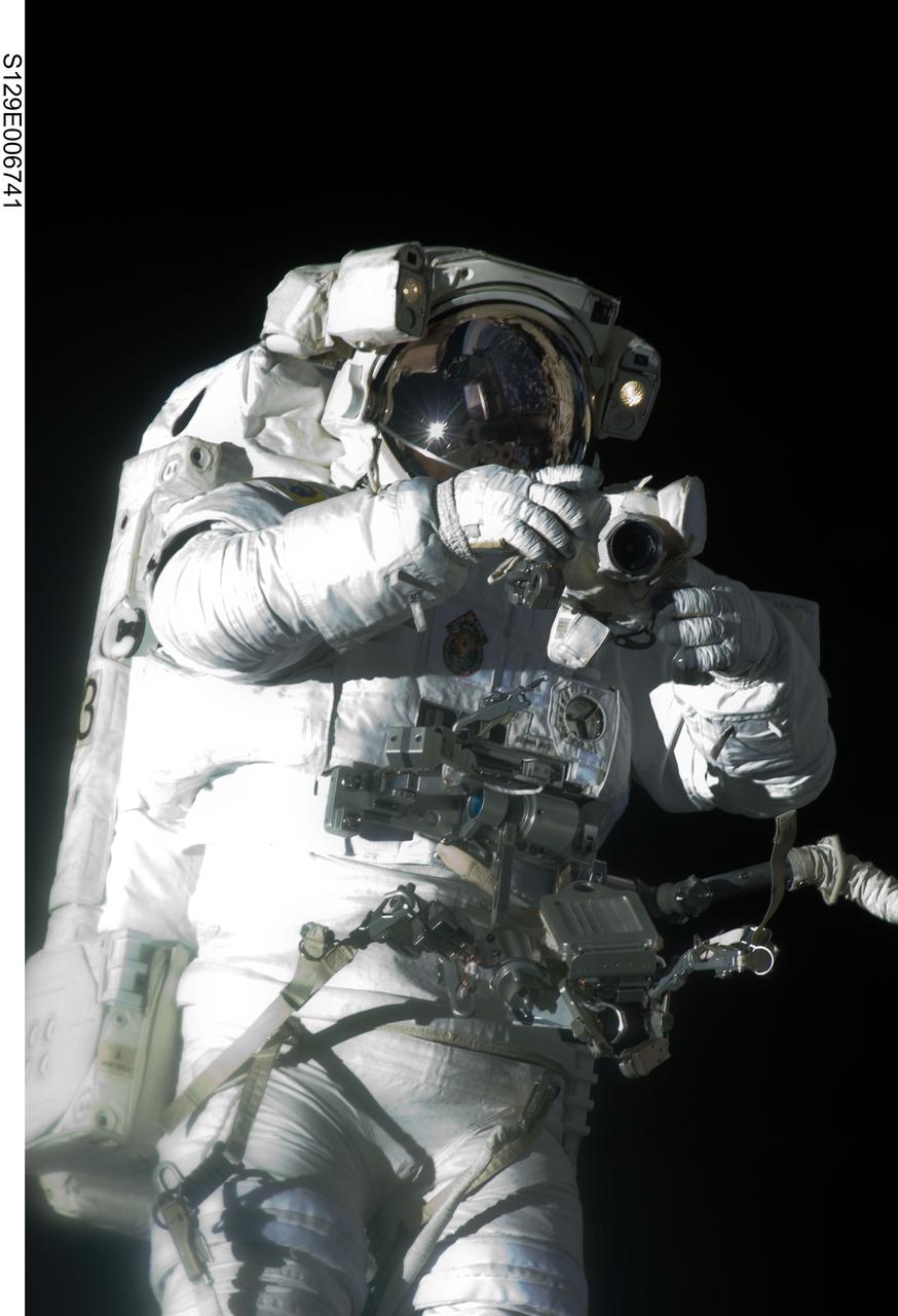 S129-E-006741 (19 Nov. 2009) --- Astronaut Robert L. Satcher Jr., STS-129 mission specialist, participates in the mission's first session of extravehicular activity (EVA) as construction and maintenance continue on the International Space Station. During the six-hour, 37-minute spacewalk, Satcher and astronaut Mike Foreman (out of frame), mission specialist, installed a spare S-band antenna structural assembly to the Z1 segment of the station?s truss, or backbone. Foreman and Satcher also installed a set of cables for a future space-to-ground antenna on the Destiny laboratory and replaced a handrail on the Unity node with a new bracket used to route an ammonia cable that will be needed for the Tranquility node when it is delivered next year. The two spacewalkers also repositioned a cable connector on Unity, checked S0 truss cable connections, and lubricated latching snares on the Kibo robotic arm and the station?s mobile base system.