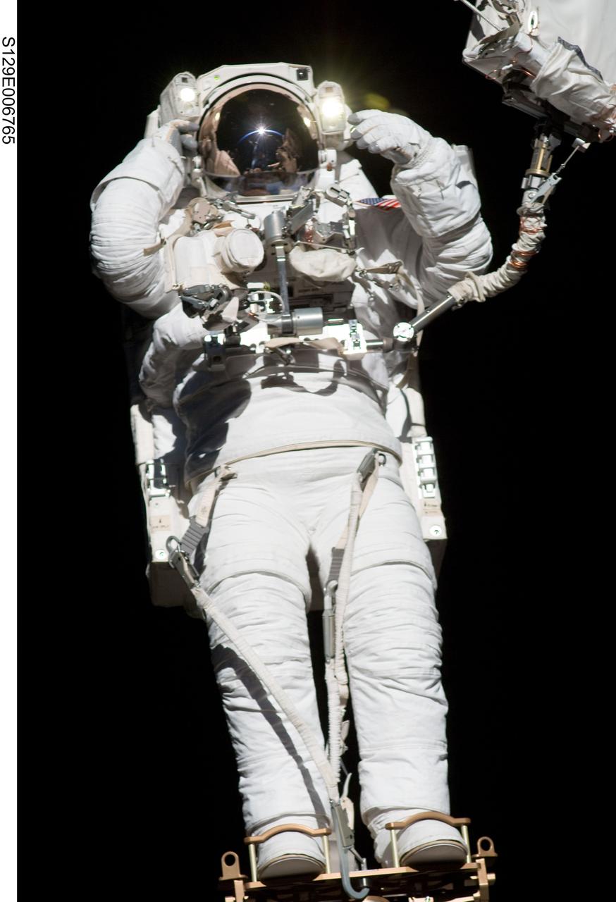 S129-E-006765 (19 Nov. 2009) --- Anchored to a Canadarm2 mobile foot restraint, astronaut Robert L. Satcher Jr., STS-129 mission specialist, participates in the mission's first session of extravehicular activity (EVA) as construction and maintenance continue on the International Space Station. During the six-hour, 37-minute spacewalk, Satcher and astronaut Mike Foreman (out of frame), mission specialist, installed a spare S-band antenna structural assembly to the Z1 segment of the station?s truss, or backbone. Foreman and Satcher also installed a set of cables for a future space-to-ground antenna on the Destiny laboratory and replaced a handrail on the Unity node with a new bracket used to route an ammonia cable that will be needed for the Tranquility node when it is delivered next year. The two spacewalkers also repositioned a cable connector on Unity, checked S0 truss cable connections, and lubricated latching snares on the Kibo robotic arm and the station?s mobile base system.