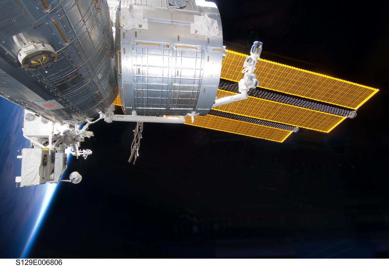 S129-E-006806 (19 Nov. 2009) --- Backdropped by Earth?s horizon and the blackness of space, the Japanese Kibo complex of the International Space Station is featured in this image photographed by an STS-129 crew member while Space Shuttle Atlantis remains docked with the station.