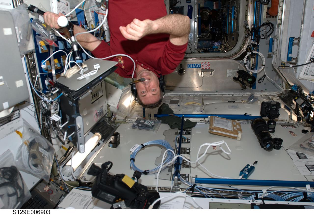 S129-E-006903 (20 Nov. 2009) --- Astronaut Mike Foreman, STS-129 mission specialist, uses a communication system while working in the Harmony node of the International Space Station while Space Shuttle Atlantis remains docked with the station.