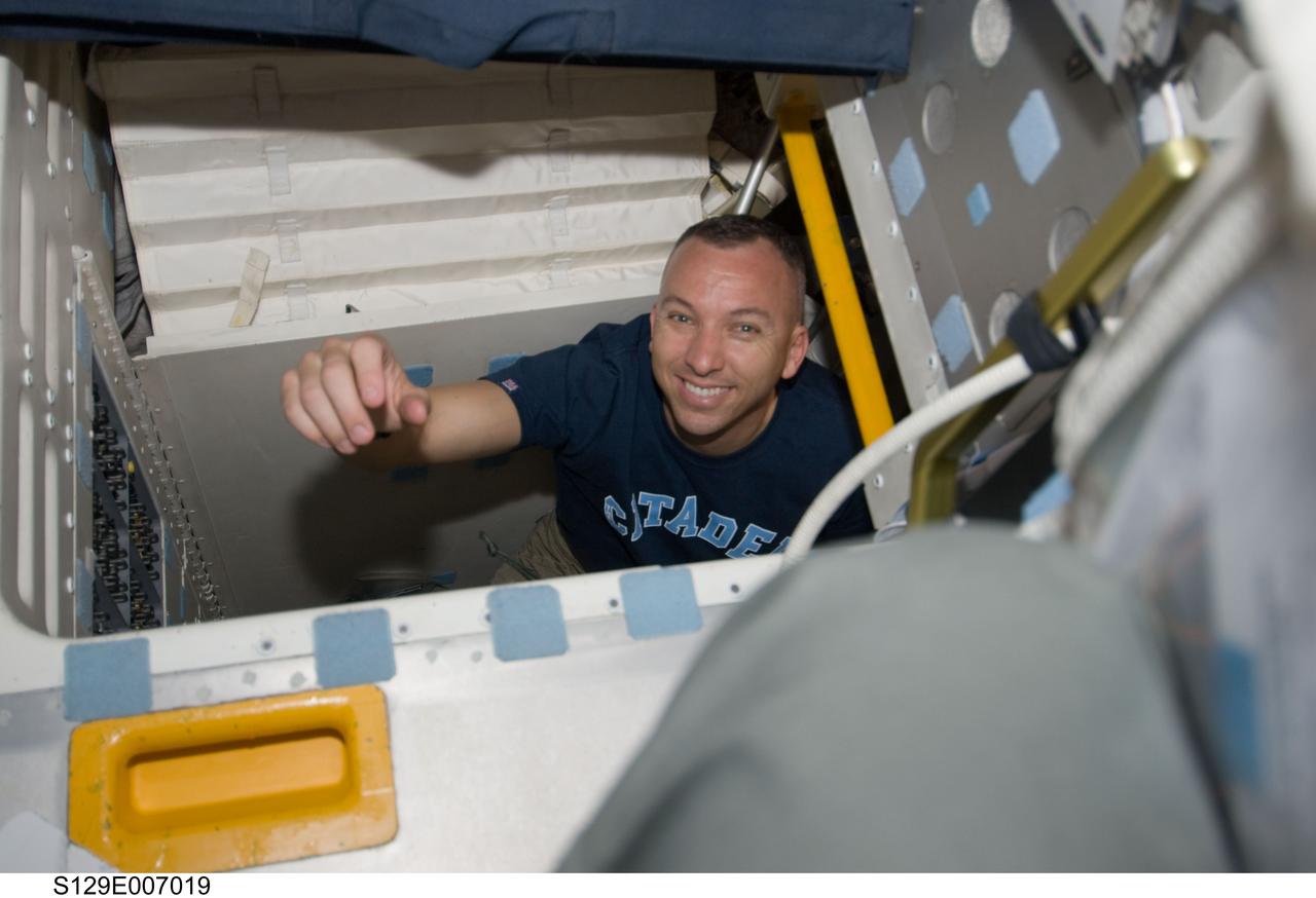 S129-E-007019 (18 Nov. 2009) --- Astronaut Randy Bresnik, STS-129 mission specialist, is pictured in the hatch which connects the flight deck and middeck of Space Shuttle Atlantis during flight day three activities.
