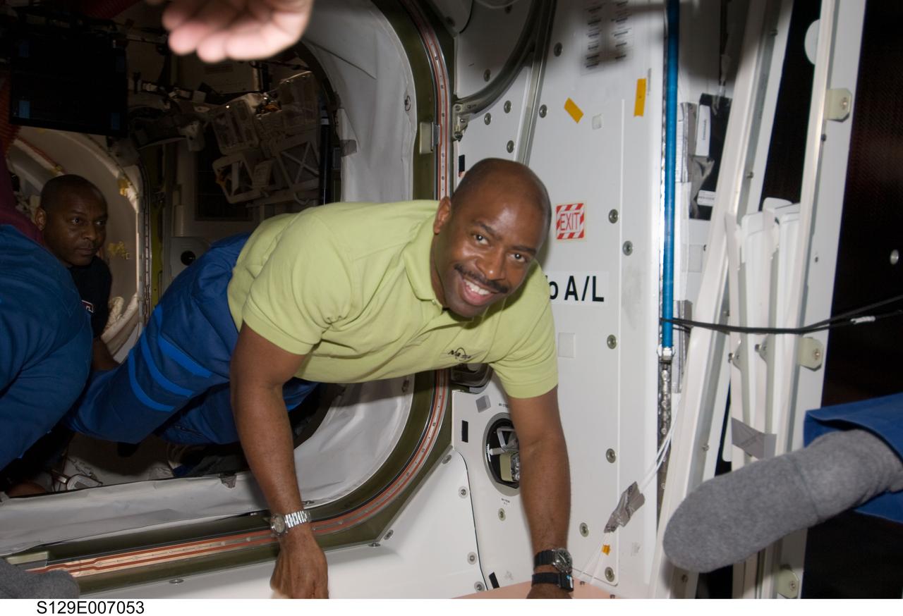 S129-E-007053 (18 Nov. 2009) --- Astronaut Leland Melvin, STS-129 mission specialist, enters the International Space Station shortly after Space Shuttle Atlantis and the International Space Station docked and the hatches were opened on Nov. 18, 2009. Astronaut Robert L. Satcher Jr., mission specialist, is at left.