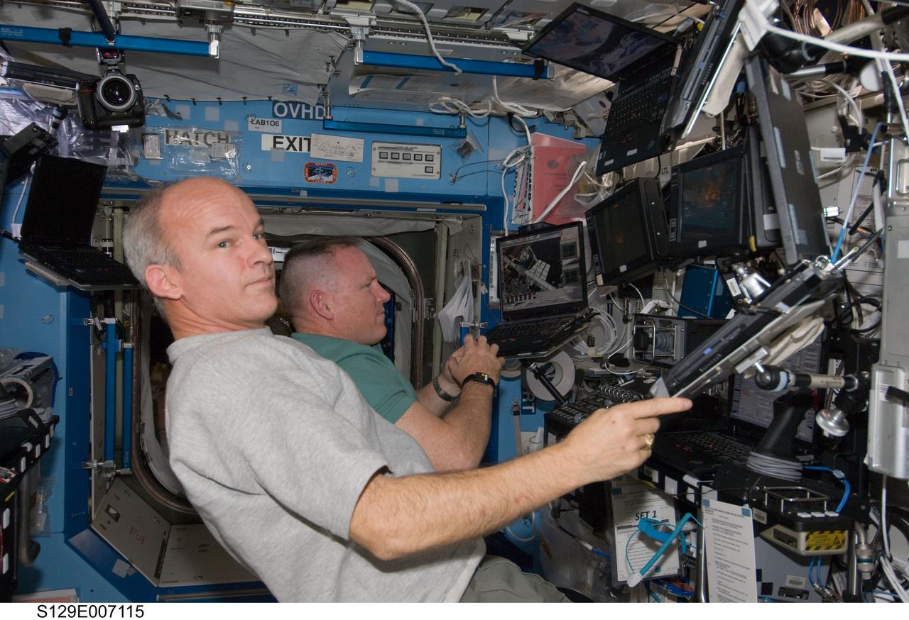 STS-129/Expedition 21 Crew Members transfer the ELC1 from Atlantis to the ISS