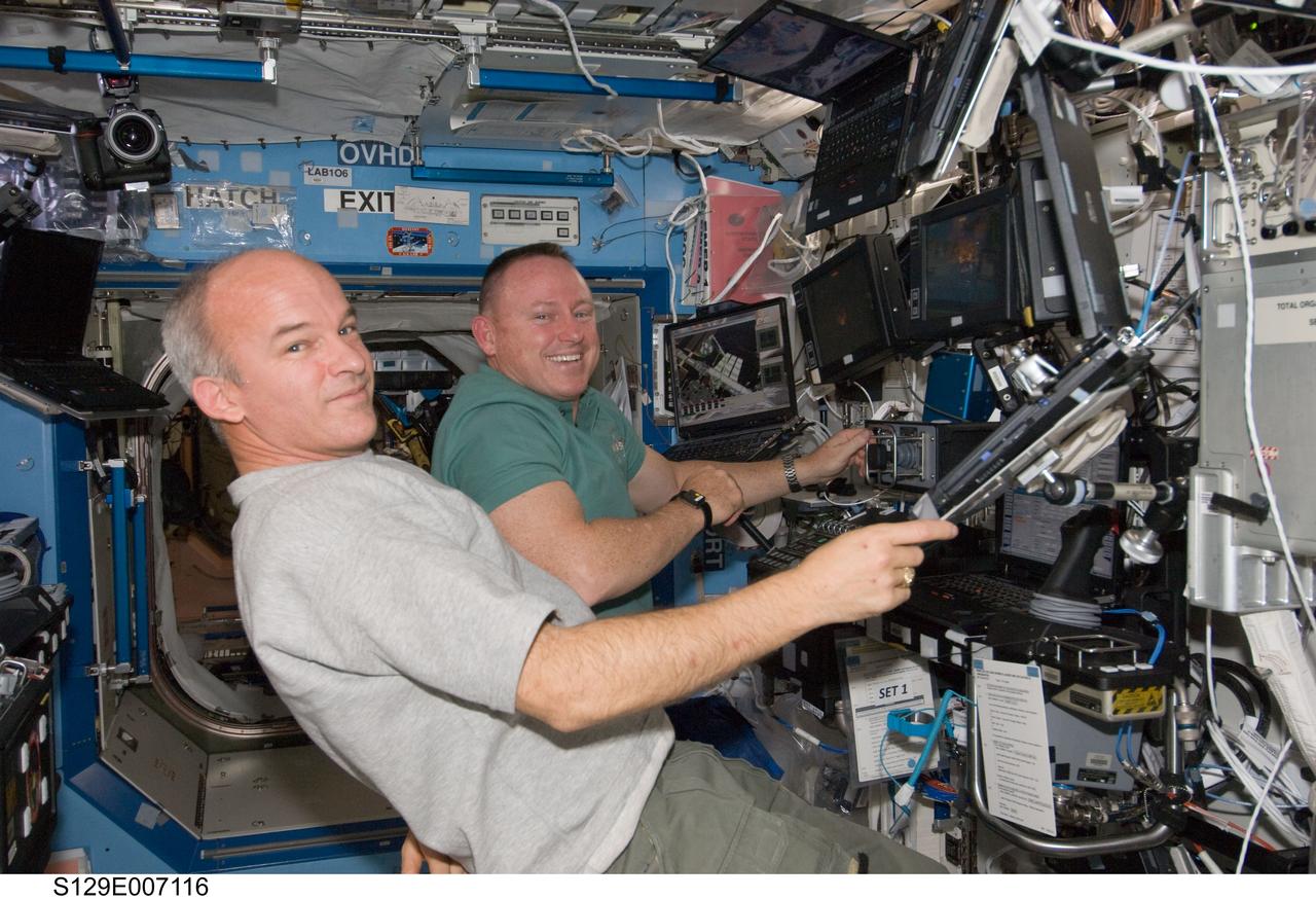 STS-129/Expedition 21 Crew Members transfer the ELC1 from Atlantis to the ISS