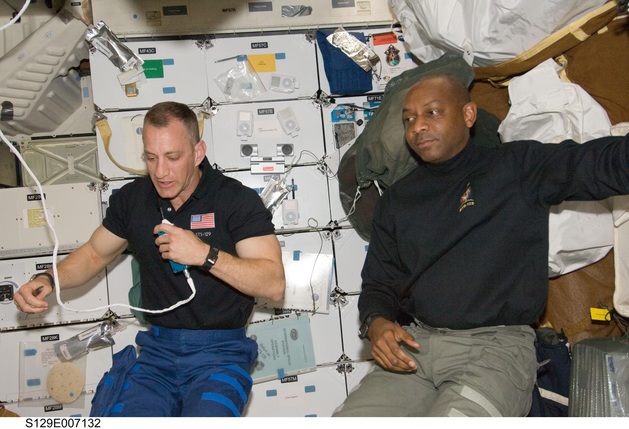 S129-E-007132 (20 Nov. 2009) --- Astronauts Charles O. Hobaugh (left), STS-129 commander; and Robert L. Satcher Jr., mission specialist, are pictured on the middeck of Space Shuttle Atlantis while docked with the International Space Station.