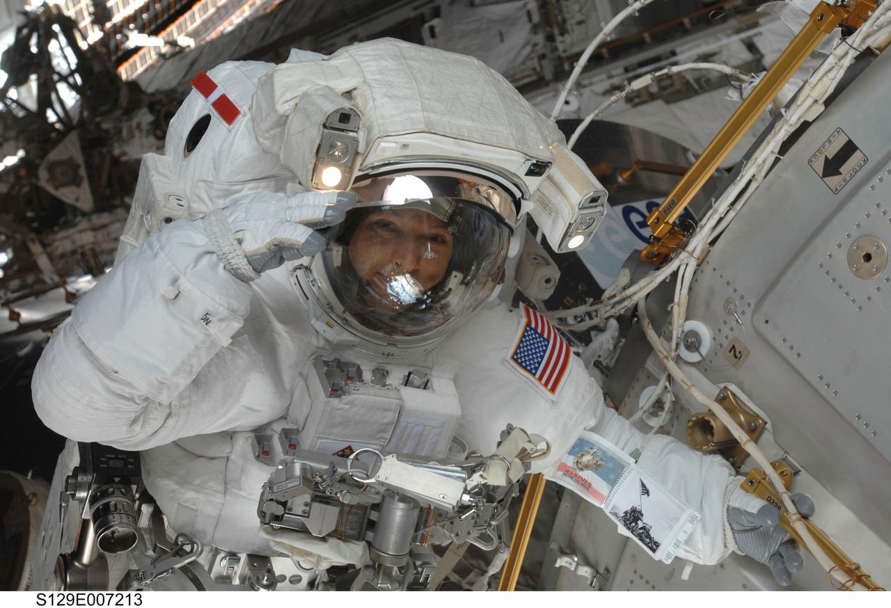 S129-E-007213 (21 Nov. 2009) --- Astronaut Randy Bresnik, STS-129 mission specialist,  salutes crewmates while positioned near the European Space Agency’s Columbus module on International Space Station.  Astronauts Bresnik and Mike Foreman were in the midst of the second of three scheduled spacewalks for this shuttle crew, working in cooperation with the five current crewmembers for the orbital outpost and with their five Atlantis crewmates, all of whom pitched in EVA support from inside