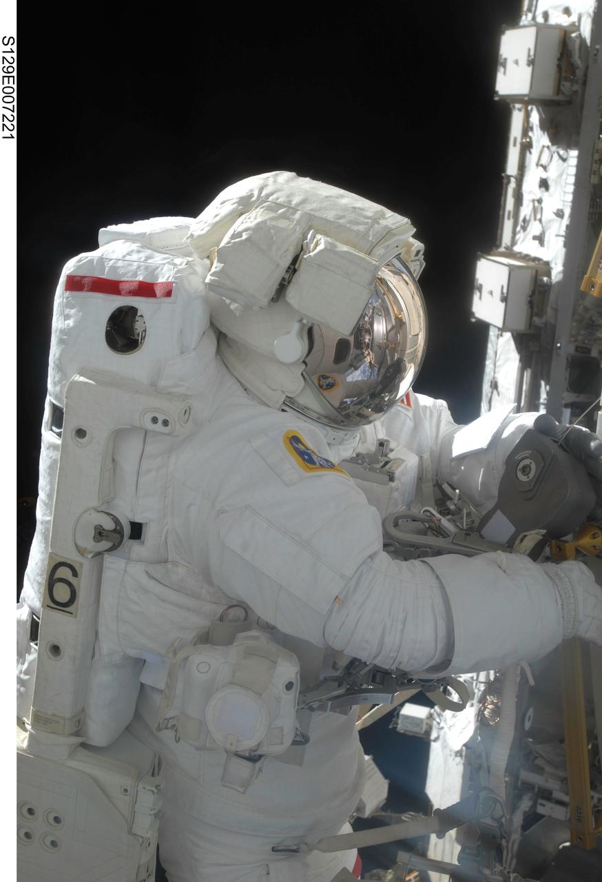 S129-E-007221 (21 Nov. 2009) --- Astronaut Mike Foreman, STS-129 mission specialist, performs a task on the exterior of the International Space Station during the second space walk of Atlantis’ visit to the orbital outpost.