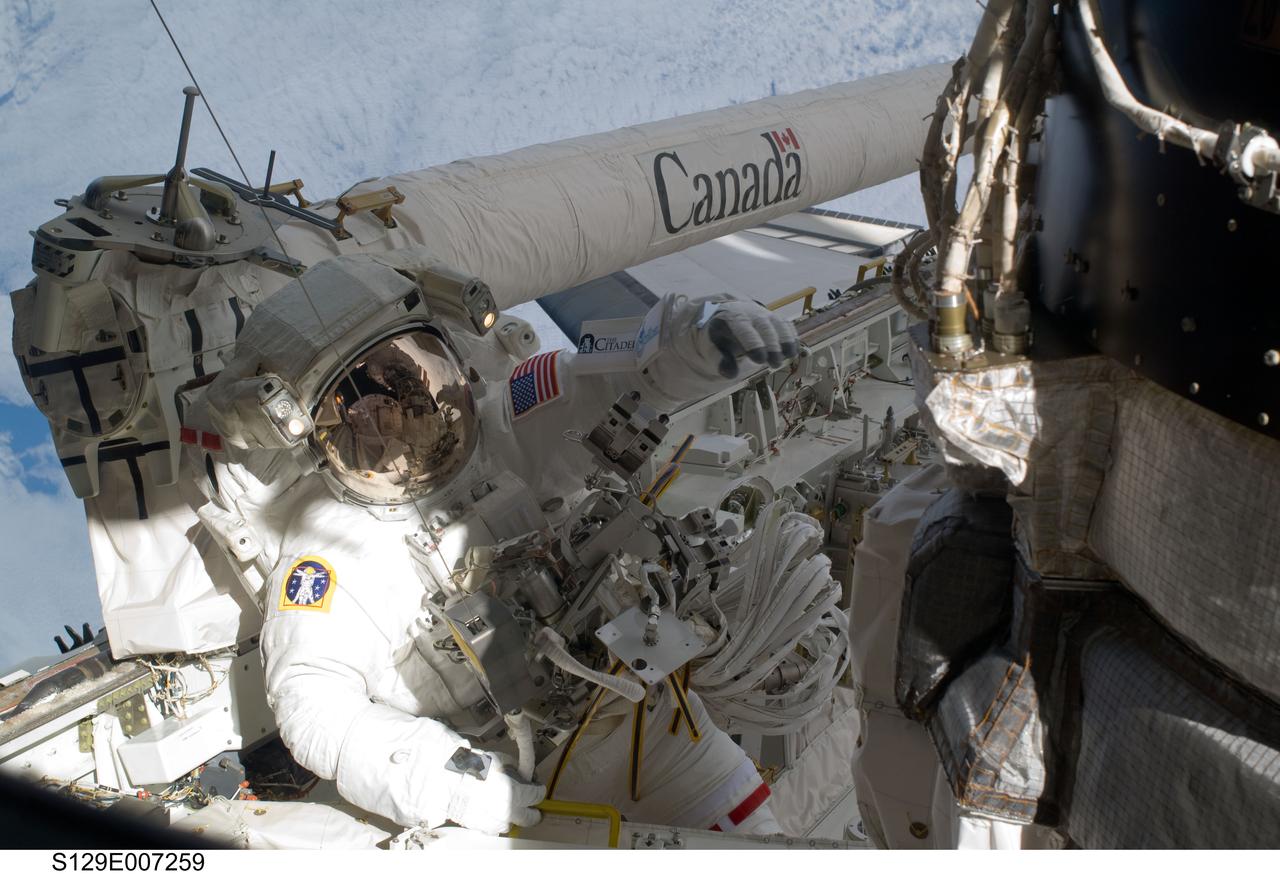 S129-E-007259 (21 Nov. 2009) --- Astronaut Randy Bresnik, STS-129 mission specialist, is pictured near the base of the Orbiter Boom Sensor System on the starboard side of the cargo bay of the space shuttle Atlantis, docked with the International Space Station.   Astronauts Bresnik and Mike Foreman were in the midst of the second of three scheduled spacewalks for this shuttle crew, working in cooperation with the five current crewmembers for the orbital outpost and with their five Atlantis crewmates, all of whom pitched in EVA support from inside.