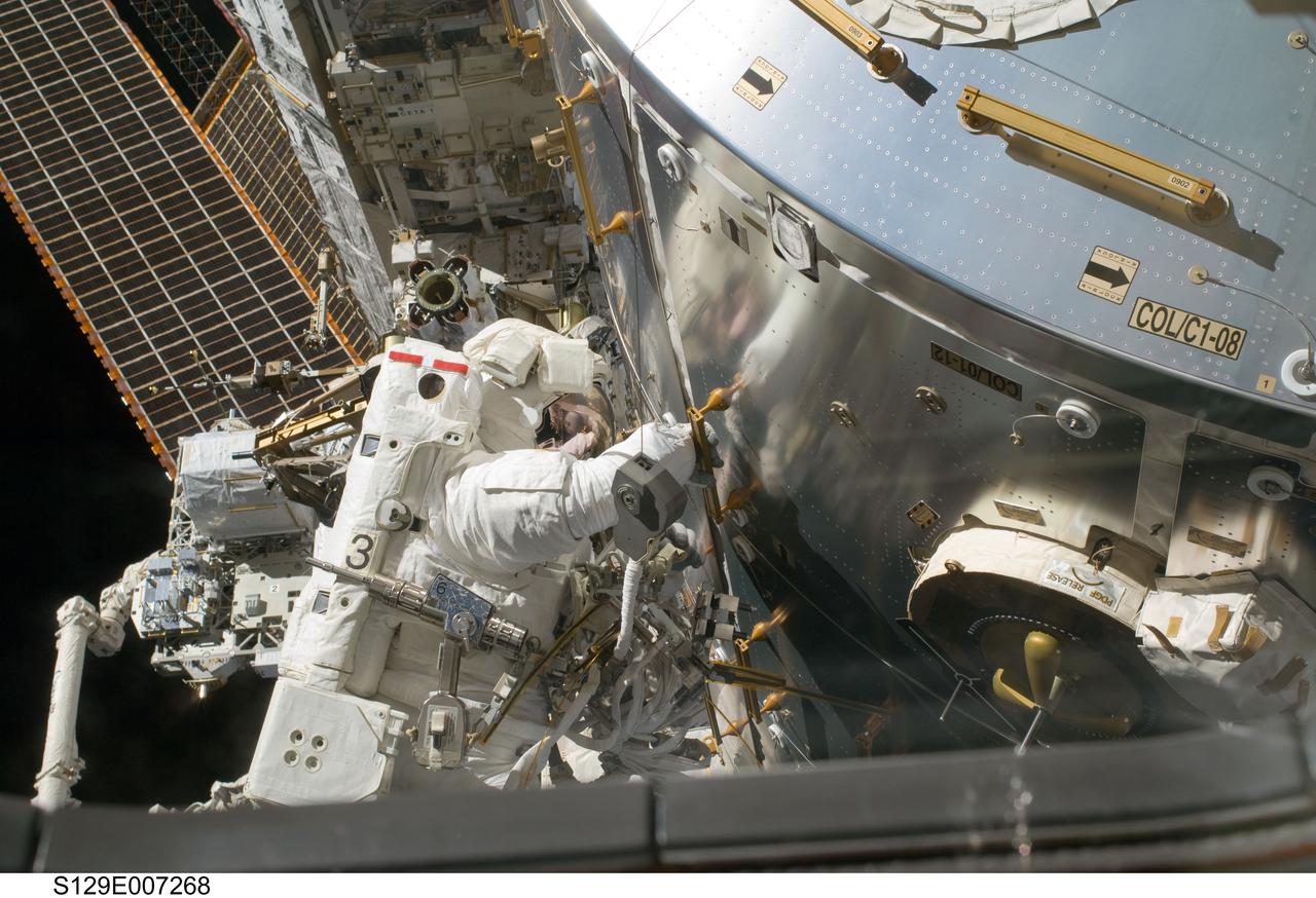S129-E-007268 (21 Nov. 2009) --- Astronaut Randy Bresnik, STS-129 mission specialist, performs a task near the European Space Agency’s Columbus module, on the International Space Station during the second space walk of the Atlantis’ visit to the orbital outpost.