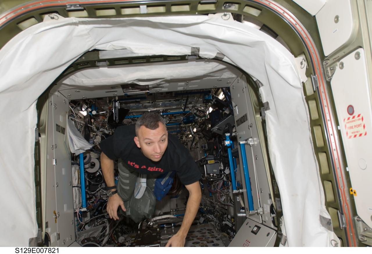 S129-E-007821 (22 Nov. 2009) --- Astronaut Randy Bresnik, STS-129 mission specialist, moves into the Unity node from the Destiny laboratory of the International Space Station while space shuttle Atlantis remains docked with the station.