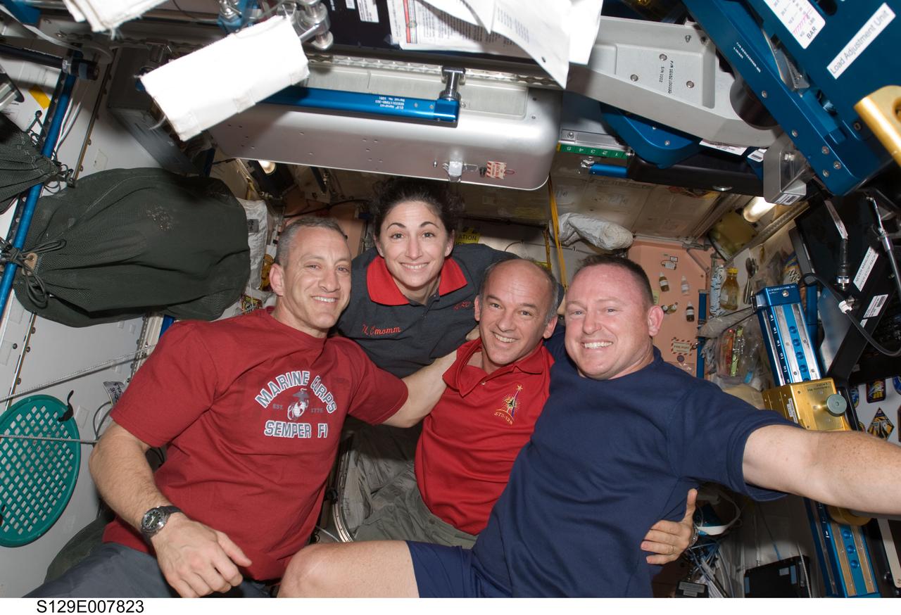 S129-E-007823 (22 Nov. 2009) --- Astronauts Charles O. Hobaugh (left), STS-129 commander; Nicole Stott, mission specialist; Jeffrey Williams, Expedition 21 flight engineer; and Barry E. Wilmore, STS-129 pilot, pose for a photo in the Unity node of the International Space Station while space shuttle Atlantis remains docked with the station.