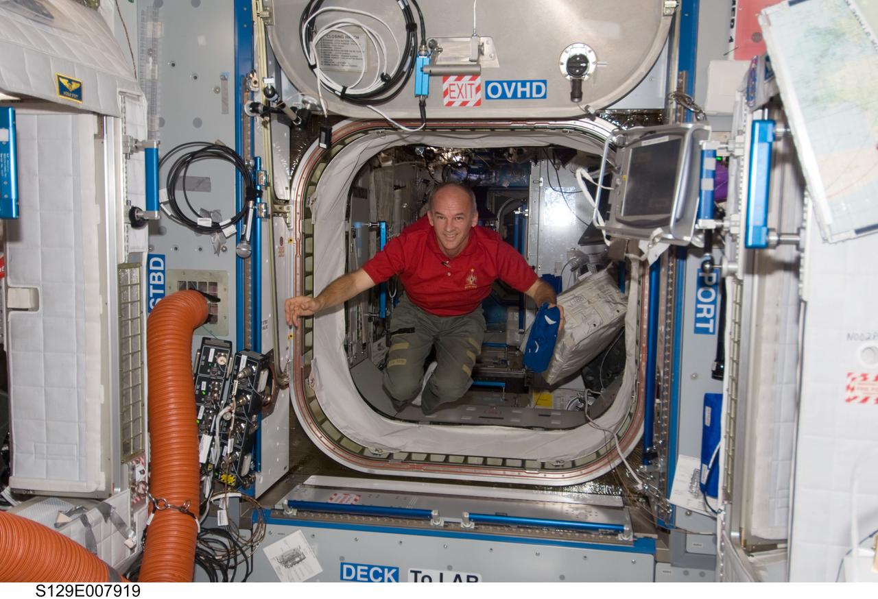 S129-E-007919 (23 Nov. 2009) --- Astronaut Jeffrey Williams, Expedition 21 flight engineer, floats into the Harmony node of the International Space Station while space shuttle Atlantis (STS-129) remains docked with the station.