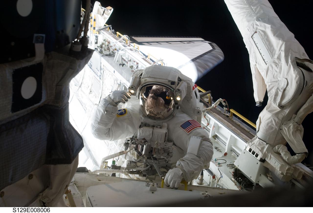 S129-E-008006 (23 Nov. 2009) --- Astronaut Randy Bresnik, STS-129 mission specialist, participates in the mission's third and final session of extravehicular activity (EVA) as construction and maintenance continue on the International Space Station. During the five-hour, 42-minute spacewalk, Bresnik and astronaut Robert L. Satcher Jr. (out of frame), mission specialist, removed a pair of micrometeoroid and orbital debris shields from the Quest airlock and strapped them to the External Stowage Platform #2, then moved an articulating foot restraint to the airlock, and released a bolt on a starboard truss ammonia tank assembly (ATA) in preparation for an STS-131 spacewalk that will replace the ATA.