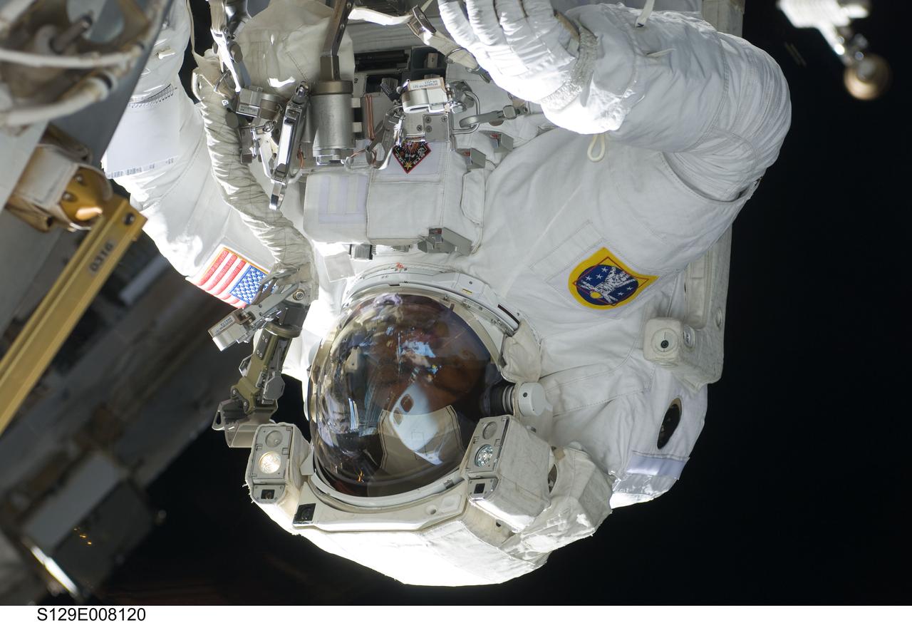 S129-E-008120 (23 Nov. 2009) --- Astronaut Robert L. Satcher Jr., STS-129 mission specialist, participates in the mission's third and final session of extravehicular activity (EVA) as construction and maintenance continue on the International Space Station. During the five-hour, 42-minute spacewalk, Satcher and astronaut Randy Bresnik (out of frame), mission specialist, removed a pair of micrometeoroid and orbital debris shields from the Quest airlock and strapped them to the External Stowage Platform #2, then moved an articulating foot restraint to the airlock, and released a bolt on a starboard truss ammonia tank assembly (ATA) in preparation for an STS-131 spacewalk that will replace the ATA.