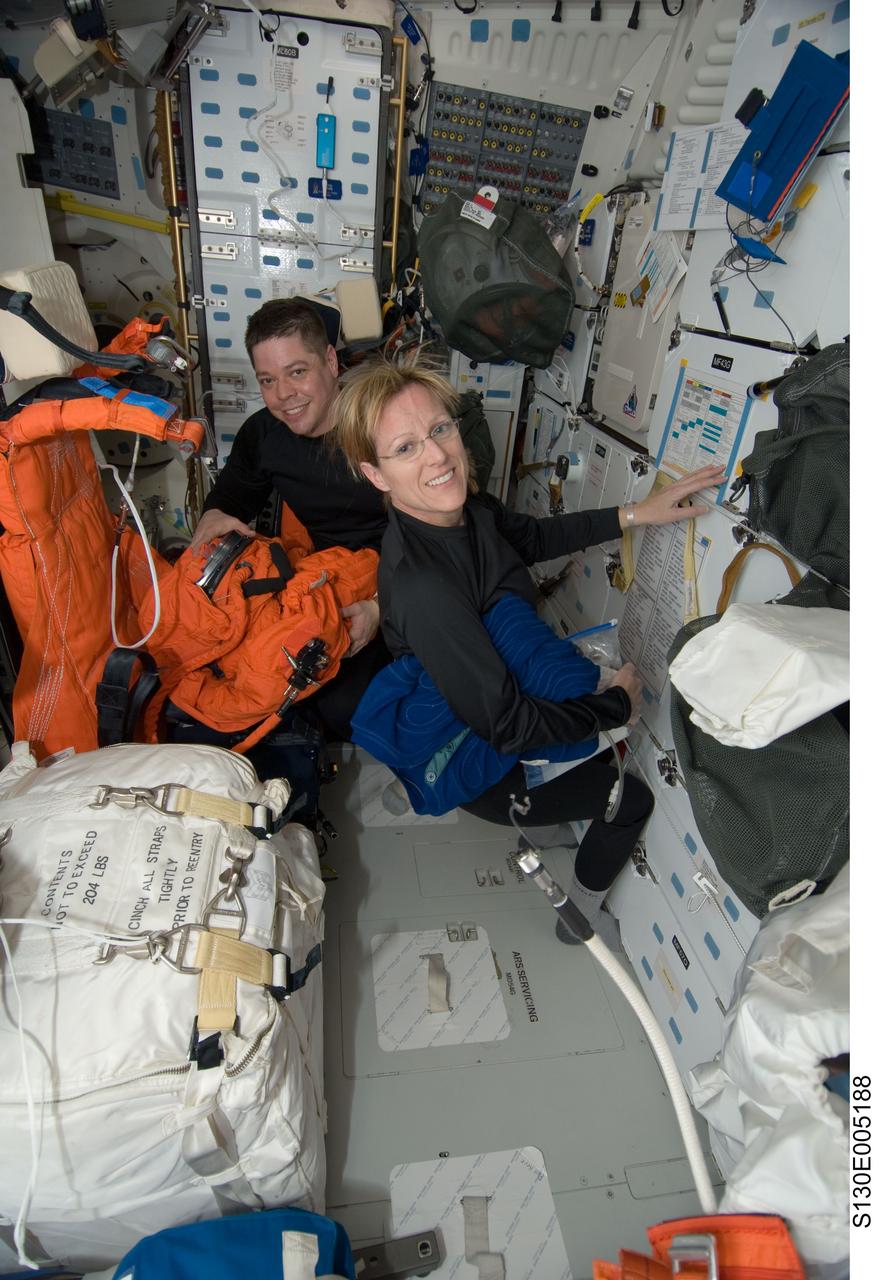 S130-E-005188 (8 Feb. 2010) --- NASA astronauts Kathryn Hire and Robert Behnken, both STS-130 mission specialists, work on the middeck of space shuttle Endeavour during postlaunch activities.
