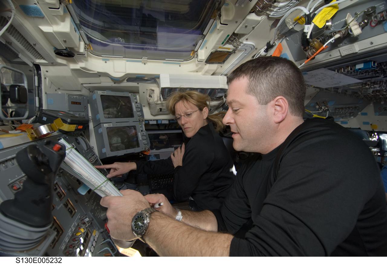 S130-E-005232 (8 Feb. 2010) --- NASA astronauts Kathryn Hire and Nicholas Patrick, both STS-130 mission specialists, work on the aft flight deck of space shuttle Endeavour during flight day one activities.