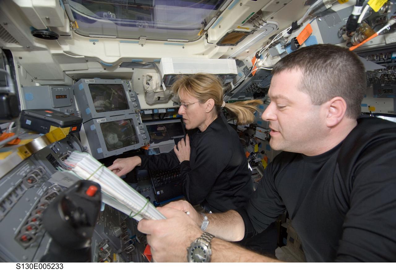 S130-E-005233 (8 Feb. 2010) --- NASA astronauts Kathryn Hire and Nicholas Patrick, both STS-130 mission specialists, work on the aft flight deck of space shuttle Endeavour during flight day one activities.