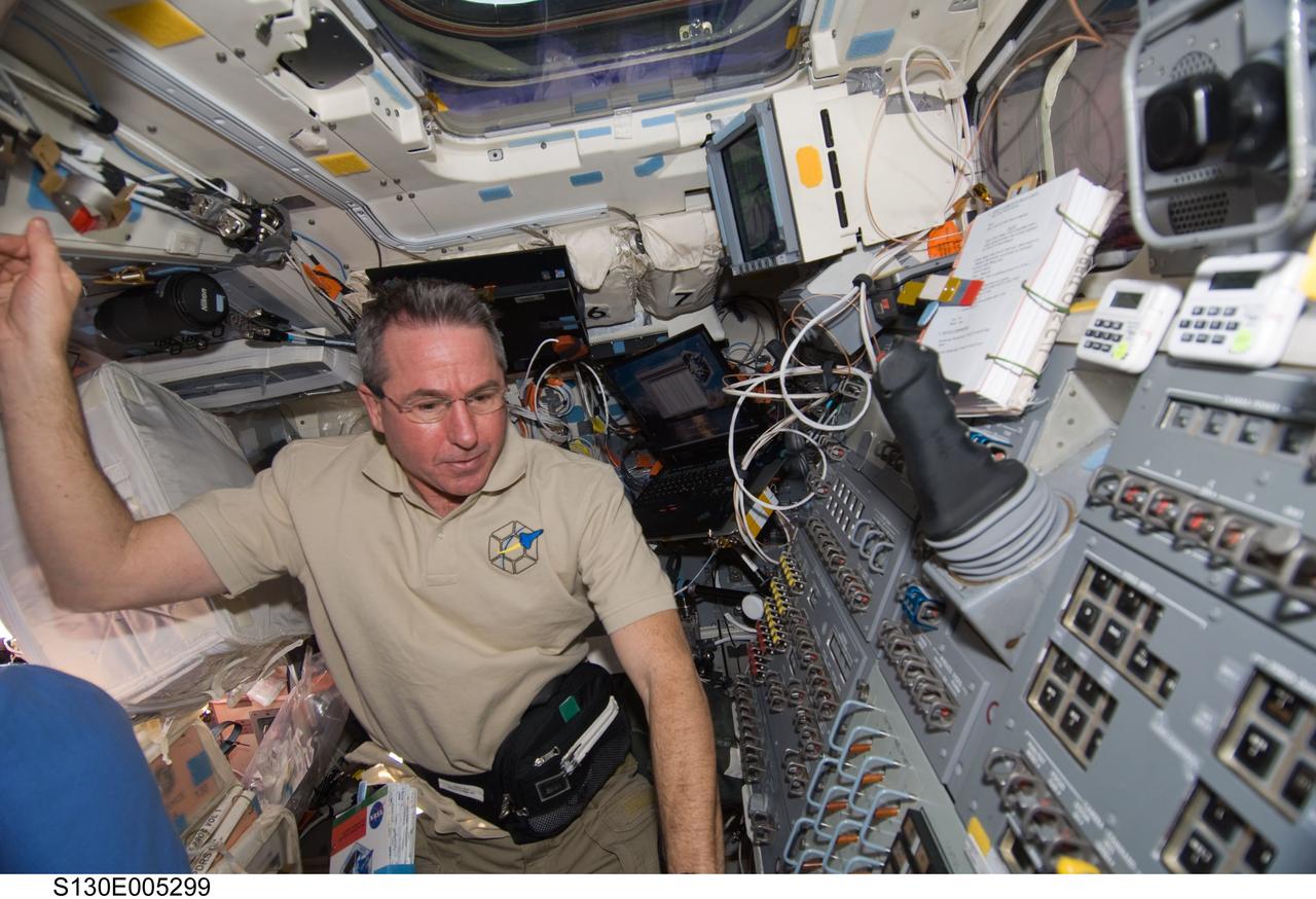 S130-E-005299 (8 Feb. 2010) --- NASA astronaut Stephen Robinson, STS-130 mission specialist, is pictured on the aft flight deck of space shuttle Endeavour during flight day one activities.